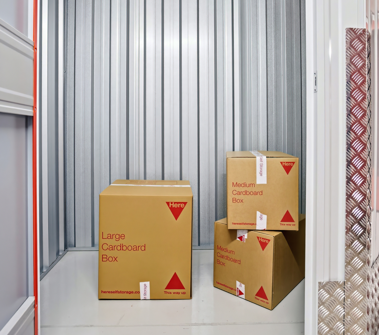3 medium sized packing boxes inside a storage unit