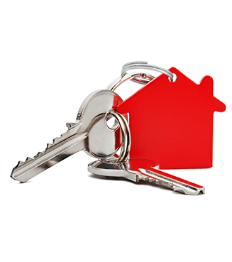 House keys attached to a red house shaped key chain
