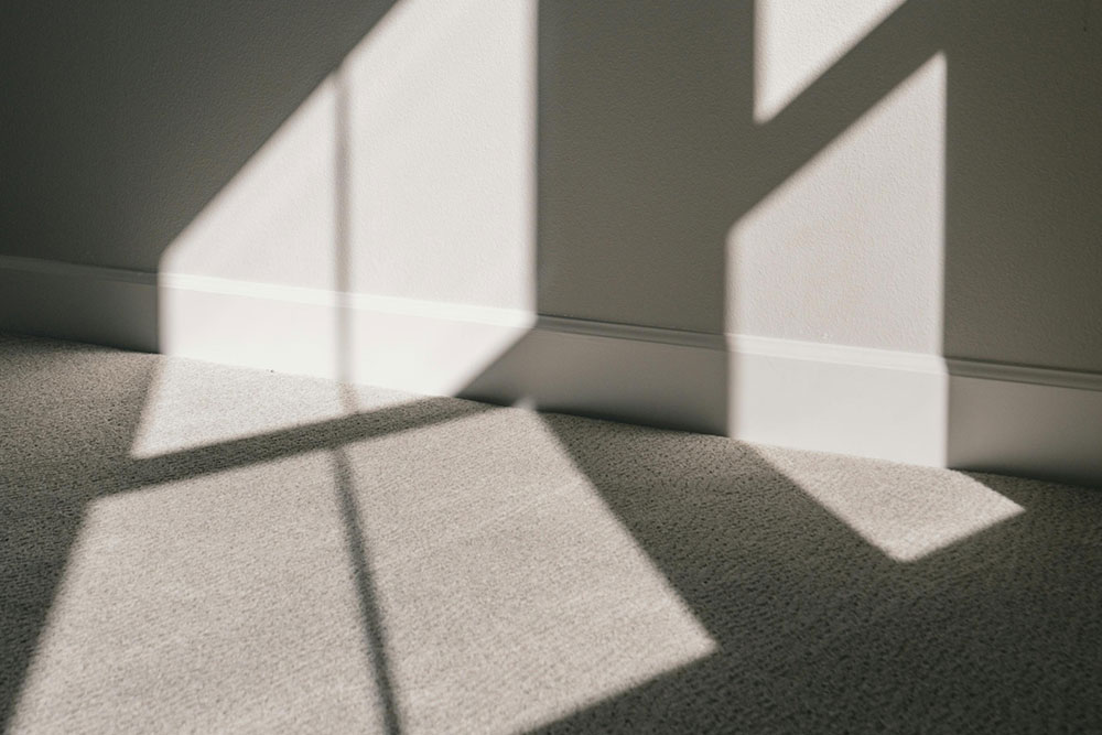 An empty room with shadows on the wall