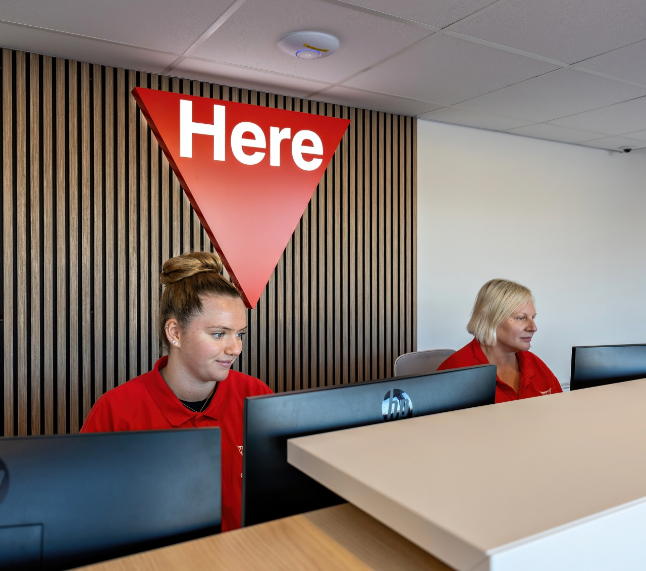 two receptonists behind the desk at reception