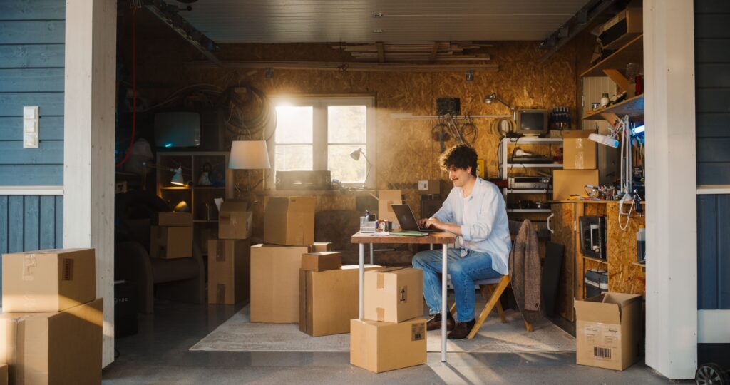Man in his garage with cardboard boxes