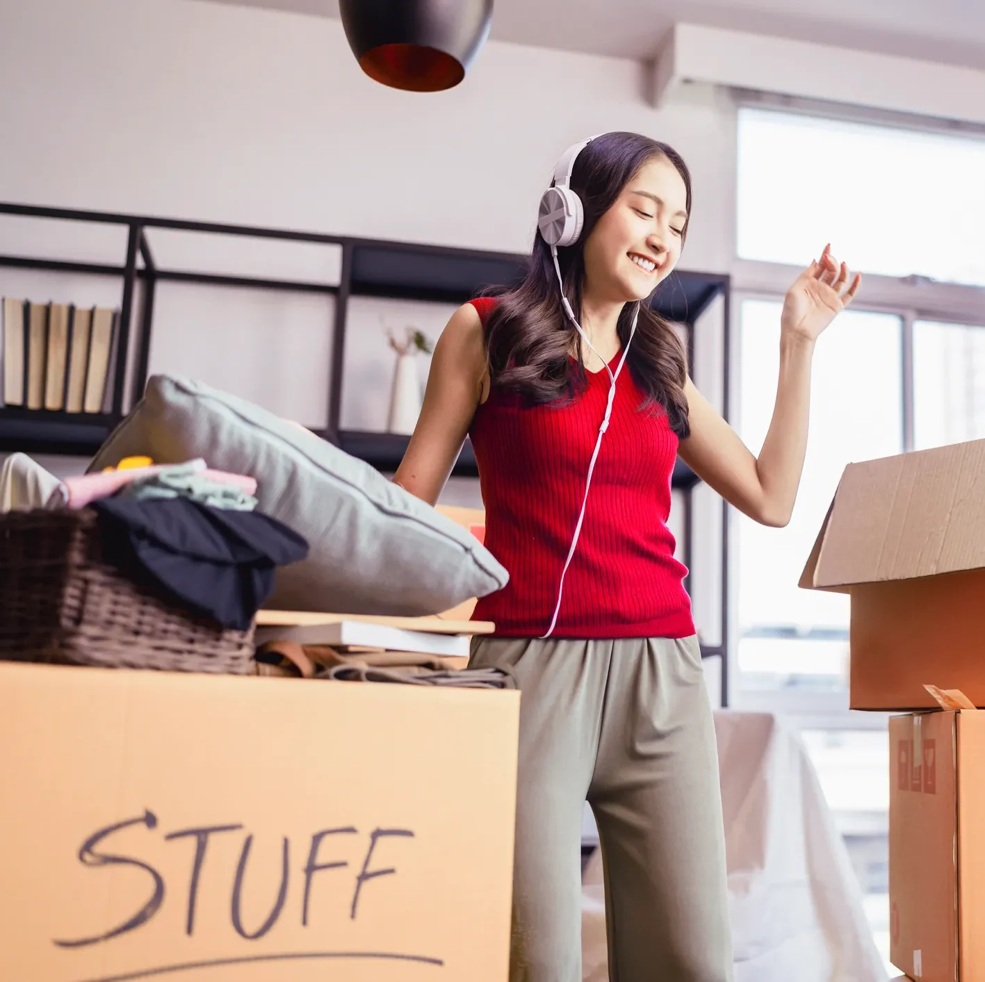 Female student packing moving boxes